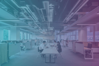 workers sitting at a desk in an office building