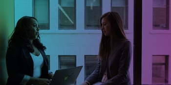 two women talking in an office building