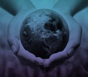 a globe being held in the palms of hands