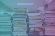 stacks of books and documents on a table